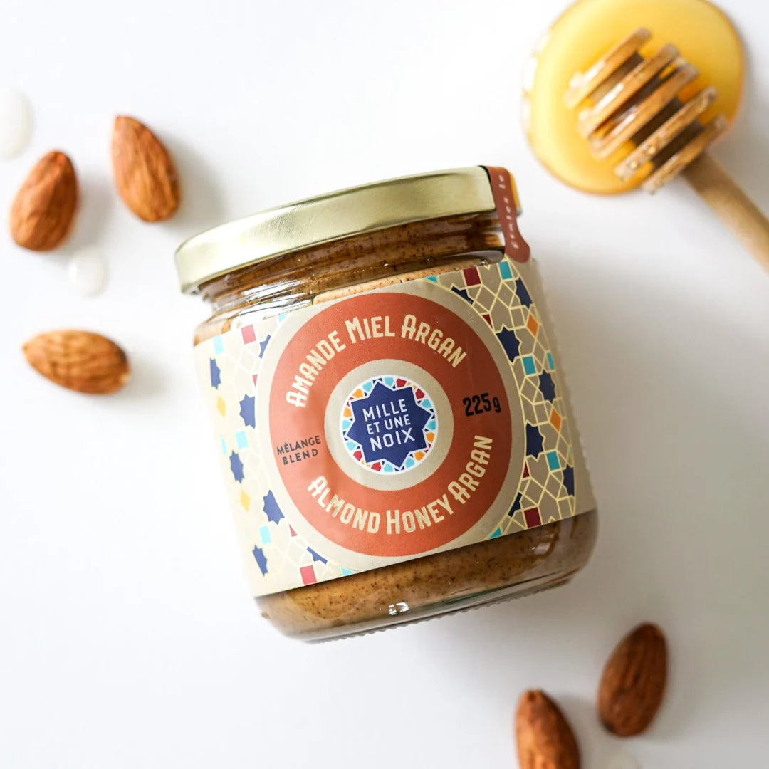 A jar of Mille et Une Noix honey argan almond butter (Amlou), featuring a smooth, nutty spread made with almonds, argan oil, and honey.