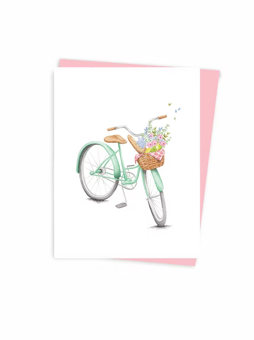 Greeting card with a basket of flowers on a green bicycle and on a white background with a pink envelope