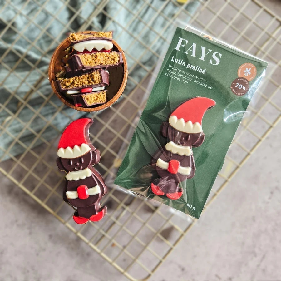 Chocolate gnomes with a FAYS packaging on a metal surface