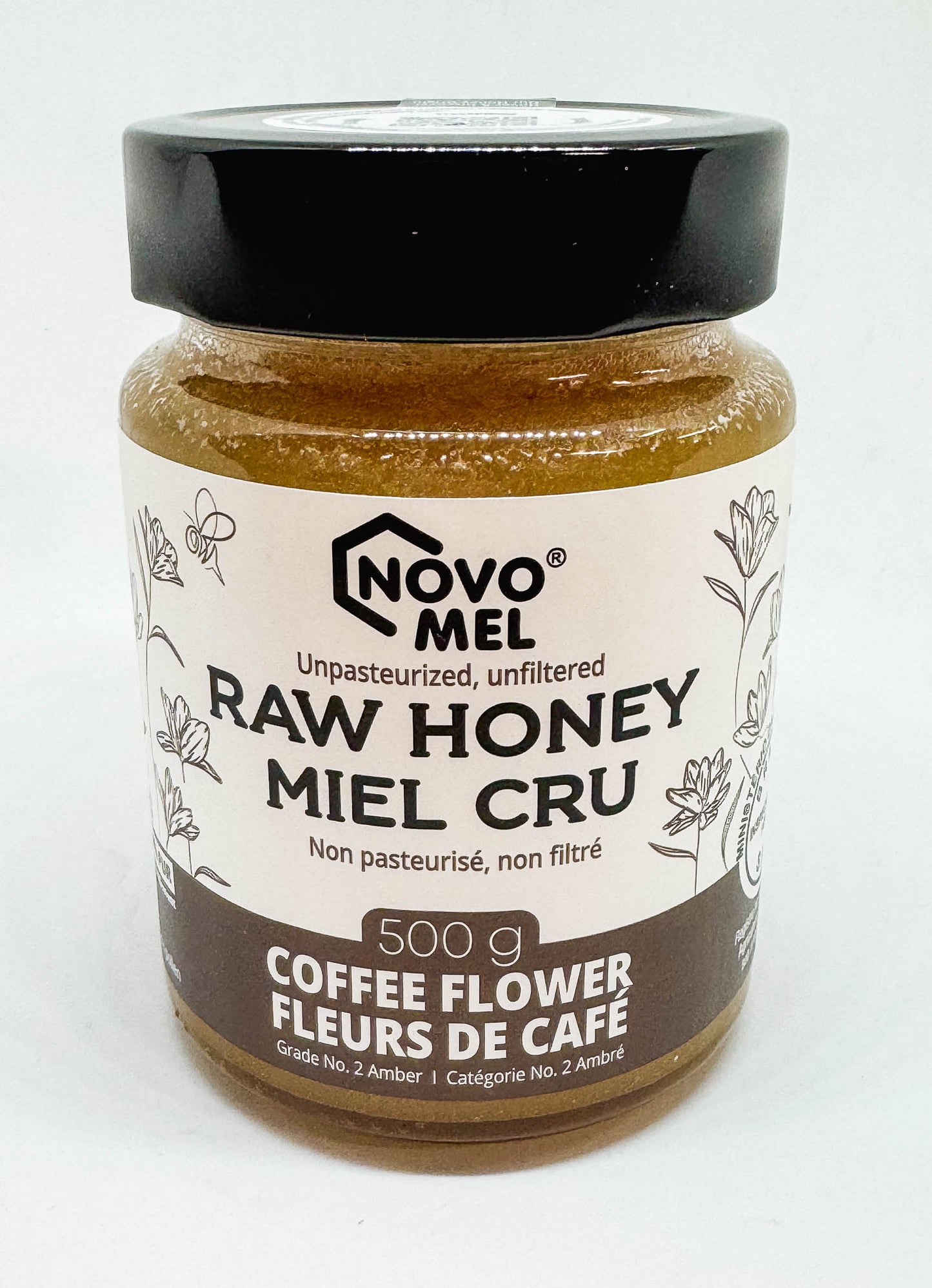 Jar of Novo Mel Raw Coffee Flower honey on a white background