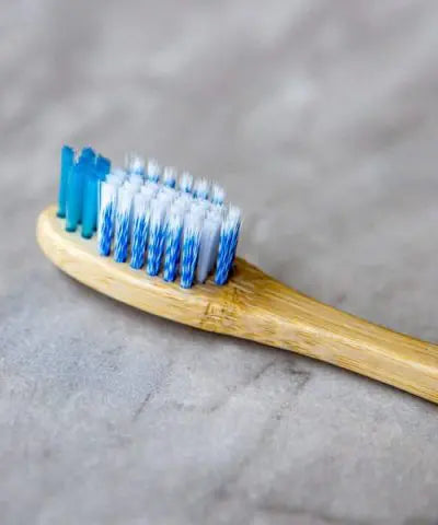 close-up of a toothbrush head with a bamboo handle