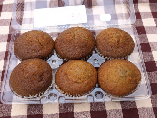 Six Quinn Farms pumpkin muffins, showcasing a soft, spiced muffin with a warm orange color in a plastic container
