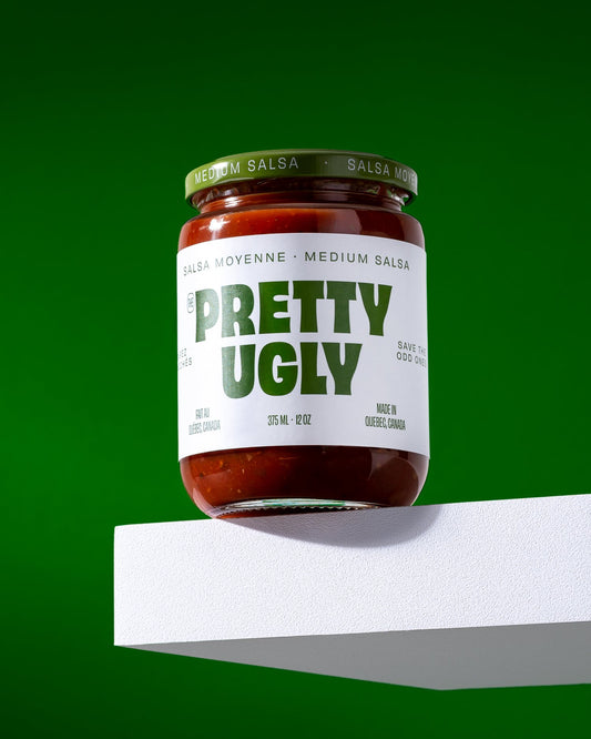 Jar of medium salsa by Pretty Ugly with green writing on a white label