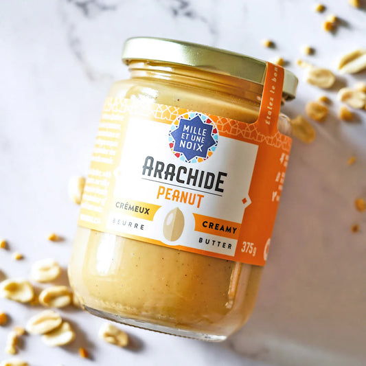 Jar of creamy organic peanut butter by Mille Et Une Noix