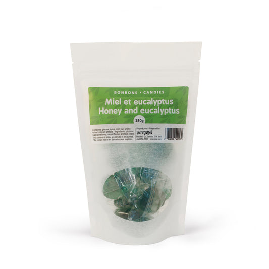 A white bag with green label with green honey and eucalyptus candies by Intermiel inside on white background