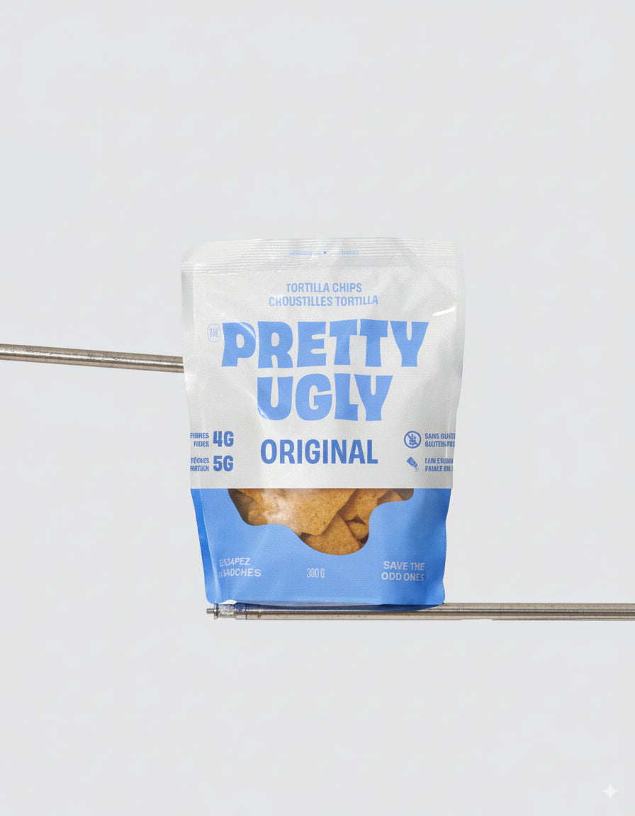 A bag of Pretty Ugly tortilla chips, featuring crispy corn chips made from upcycled ingredients in bold, branded packaging.