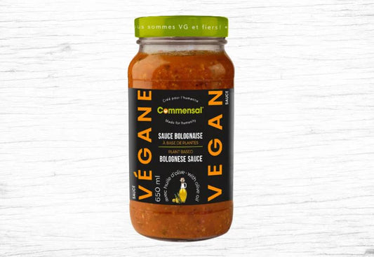 A jar of Le Commensal vegan Bolognese-style pasta sauce, featuring a rich tomato-based sauce with plant-based ingredients.