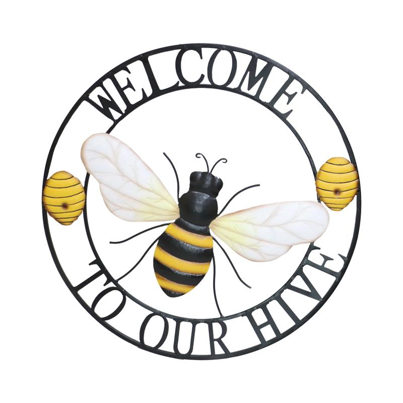 Metal welcome sign that says welcome to our hive decorated with yellow bee hives and a honeybee in the center