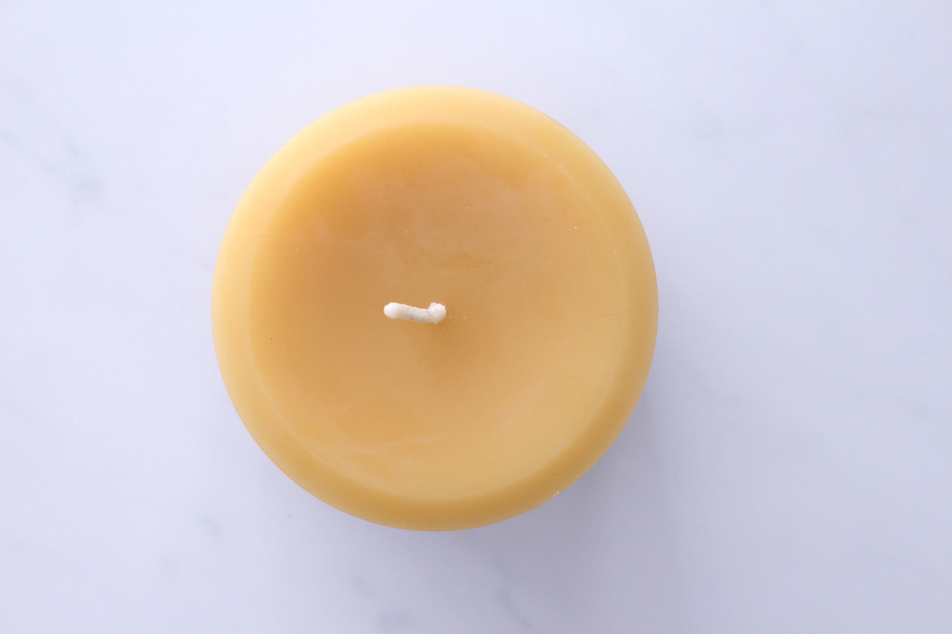 Top view of handmade beeswax pillar candle by B Factory