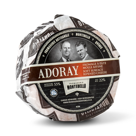 A wheel of Fromagerie Montebello Adoray cheese, featuring a soft, creamy interior with a delicate rind in branded packaging.