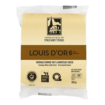 A wheel of Fromagerie du Presbytère Louis d’Or cheese, featuring a firm texture and golden interior with a natural rind.