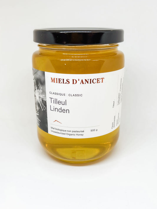glass jar of golden liquid linden honey by Miels D'Anicet 500g