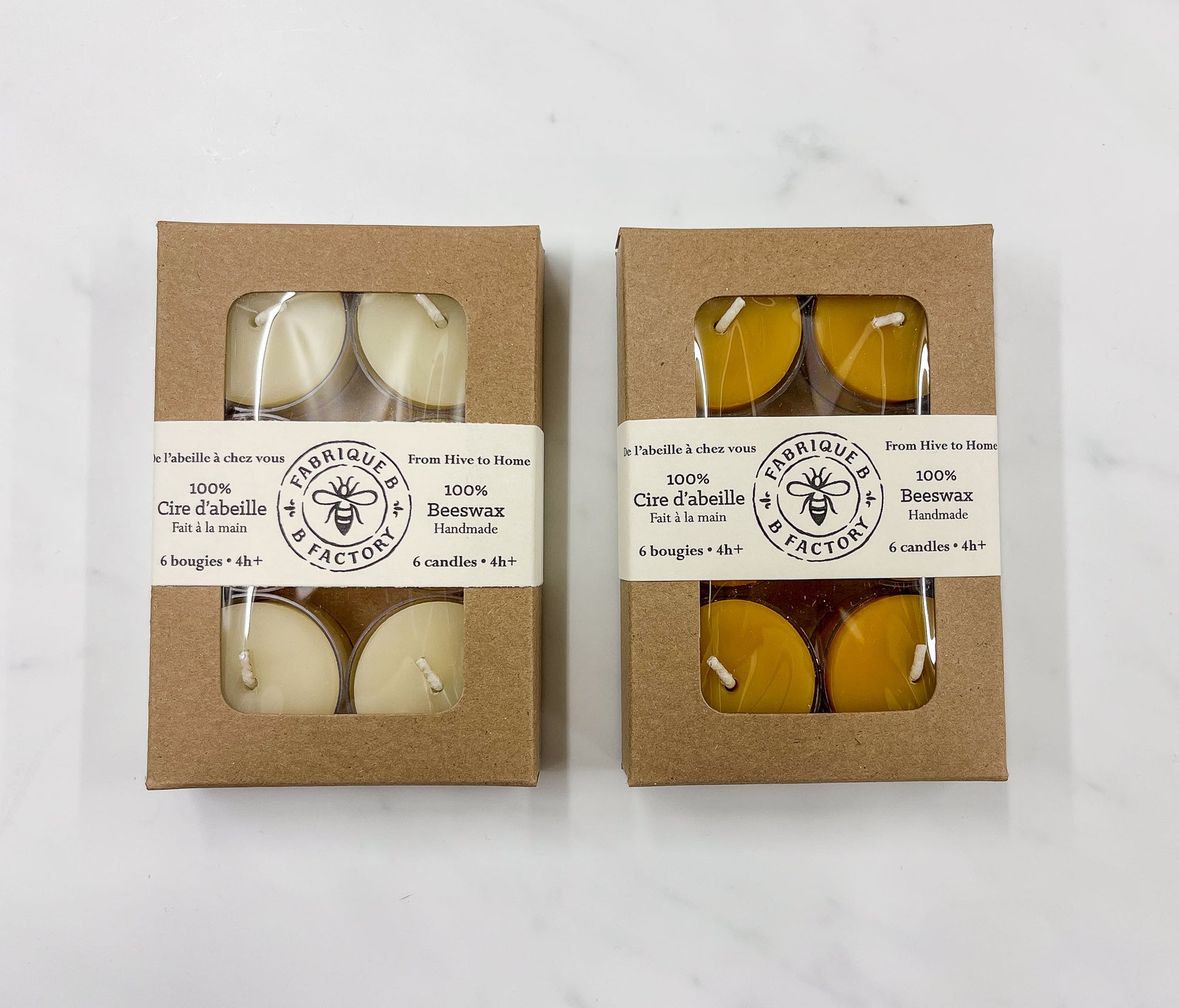 Box of 6 white tea light candles next to box of 6 pure yellow beeswax tea light candles with B Factory logo on lids