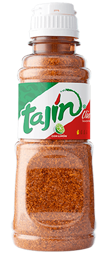 A bottle of Tajín Classic seasoning, a chili-lime spice blend featuring a mix of dried chilies, lime, and salt in a labeled container.