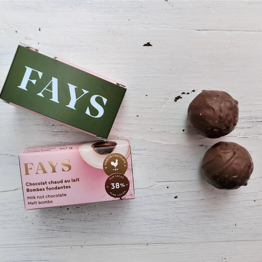 Fays milk chocolate melt bombs on a white surface