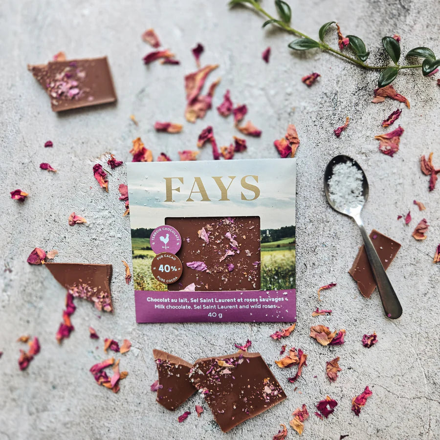 Fays chocolate packaging with chocolate pieces and dried flowers on a textured surface