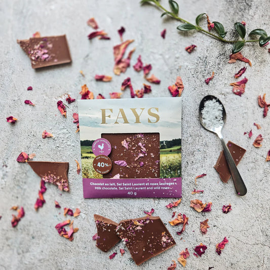Fays chocolate packaging with chocolate pieces and dried flowers on a textured surface