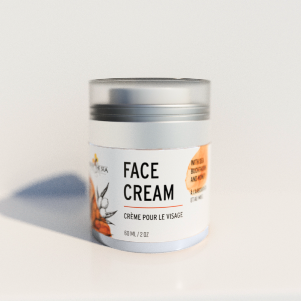 A jar labeled "Face Cream / Crème pour le visage" sits on a white background. The lid is semi-transparent and silver. The label is orange and white