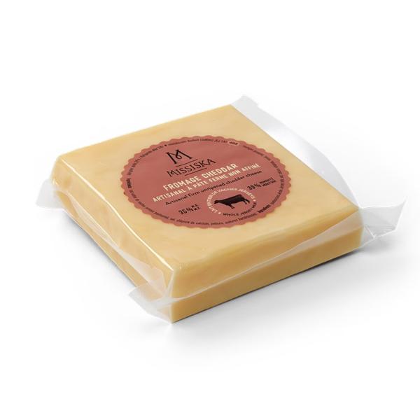 A block of Missiska mild cheddar cheese (200g), featuring a smooth, firm texture and a pale orange color in branded packaging.