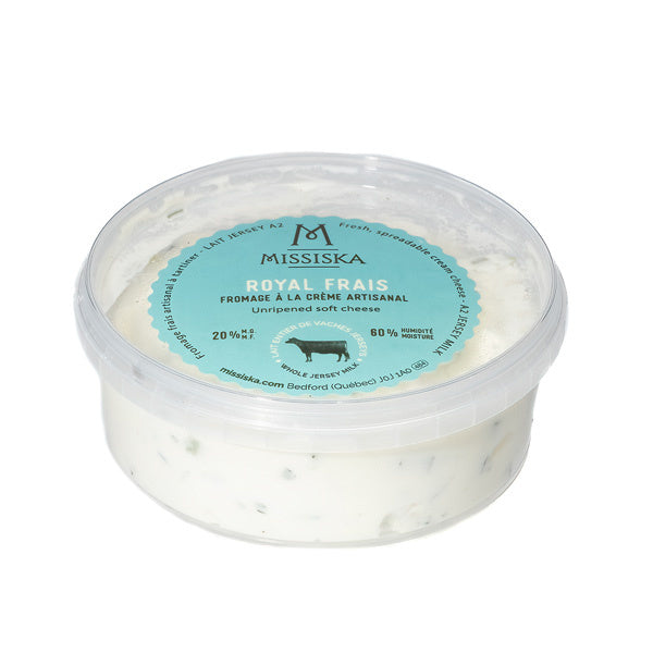 A container of Missiska Jersey milk cream cheese (250g) with fresh herbs, featuring a creamy spread with visible herbs in branded packaging.