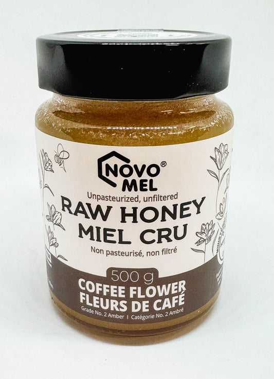 Jar of Novo Mel Raw Coffee Flower honey on a white background