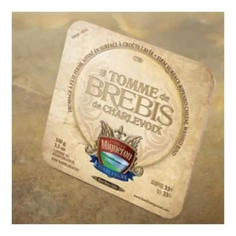 A wheel of Maison Affinage Maurice Dufour Tomme de brebis cheese, featuring a firm sheep’s milk cheese with a natural rind and creamy interior.