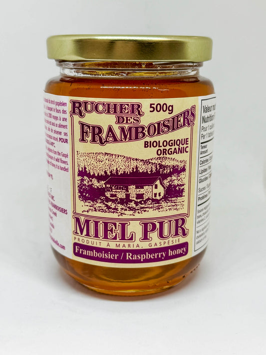 500g jar of organic Raspberry blossom honey by Rucher des Framboisiers on a white background