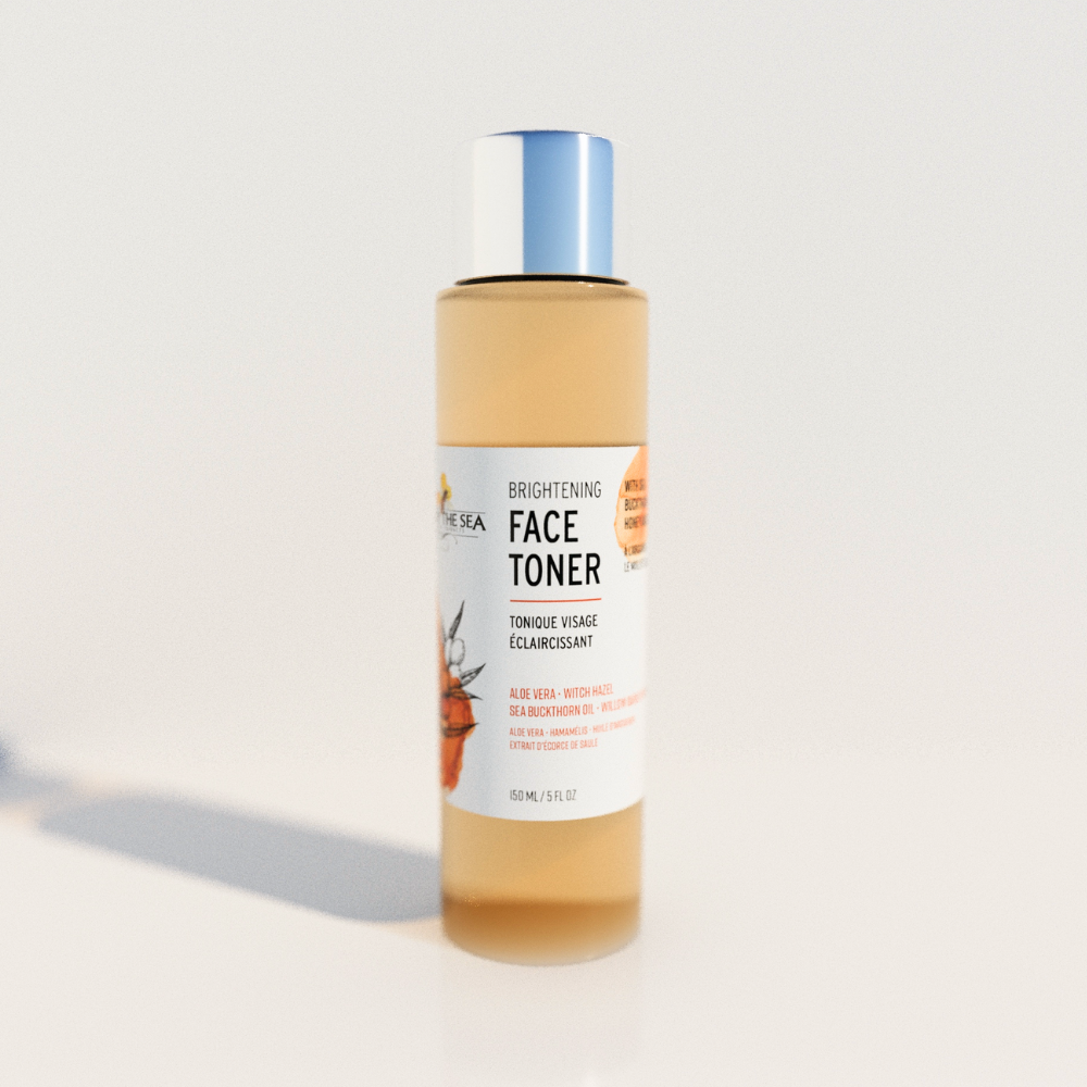 A bottle of Bee by the Sea's Face Toner sitting on a white background. The lid is silver, and the liquid is pale orange.