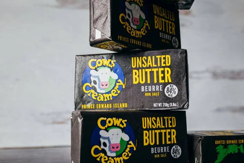 A package of Cows Creamery unsalted butter (84% fat), featuring a rich, creamy butter in branded packaging.