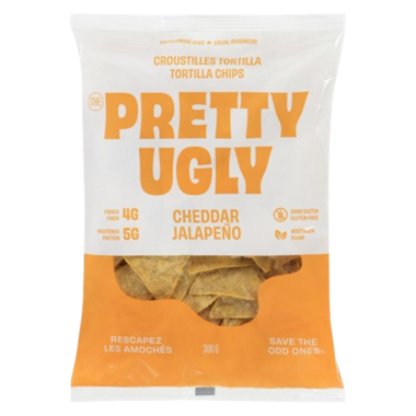 A bag of Pretty Ugly cheddar and jalapeño tortilla chips, featuring crispy corn chips with a bold cheesy and spicy flavor in branded packaging.