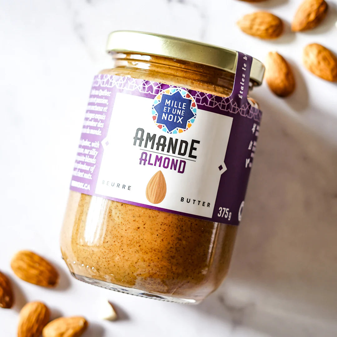 A jar of Mille et Une Noix almond butter (375g), featuring a smooth, creamy spread made from almonds in branded packaging.
