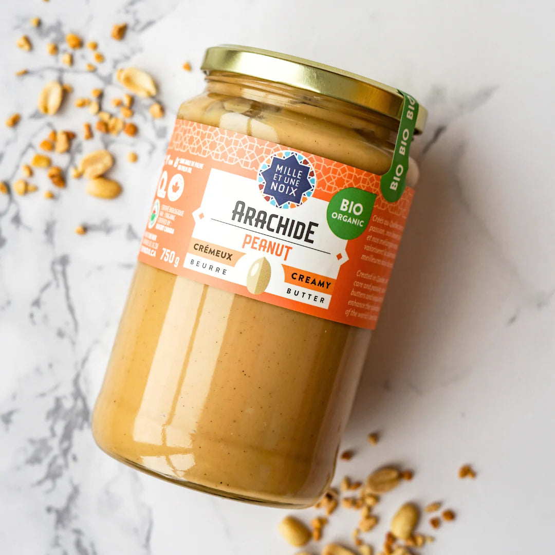A jar of Mille et Une Noix organic creamy peanut butter (750g), featuring a smooth, rich peanut spread in large-format packaging.