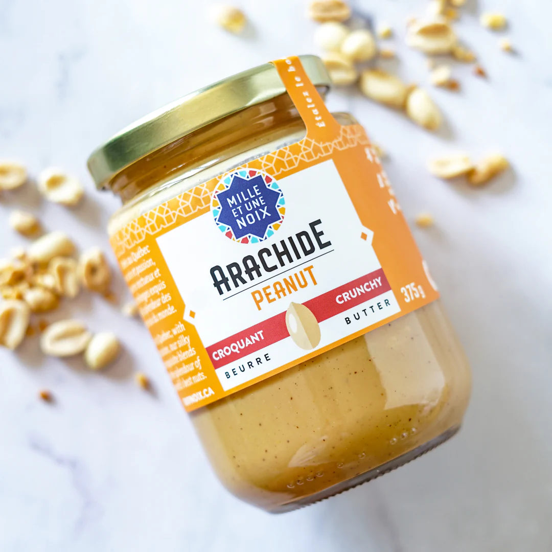 Jar of crunchy organic peanut butter by Mille Et Une Noix