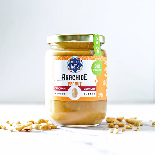Jar of crunchy organic peanut butter by Mille Et Une Noix