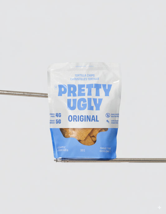 A bag of Pretty Ugly tortilla chips, featuring crispy corn chips made from upcycled ingredients in bold, branded packaging.