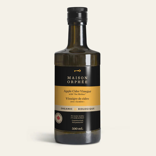 A bottle of Maison Orphée apple cider vinegar, featuring a golden liquid in a glass bottle with a labeled design for cooking and dressings.