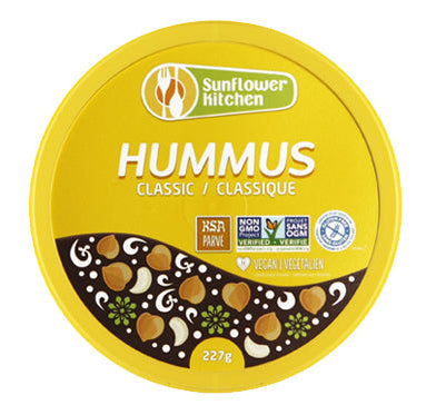 A container of Sunflower Kitchen classic hummus, featuring a smooth, creamy chickpea dip in branded packaging.