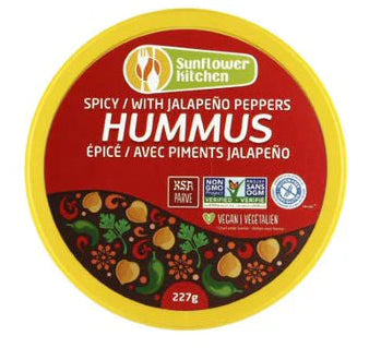 A container of Sunflower Kitchen spicy jalapeño pepper hummus, showcasing a creamy chickpea dip with a spicy kick in branded packaging.