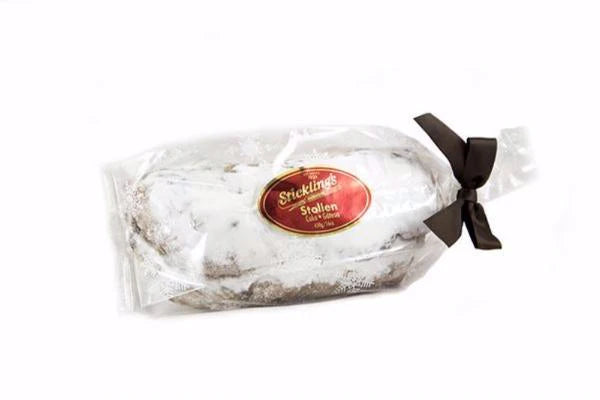 A Sticklings Stöllen cake (450g), a traditional German-style fruit bread filled with dried fruits and dusted with powdered sugar, packaged for holiday enjoyment.