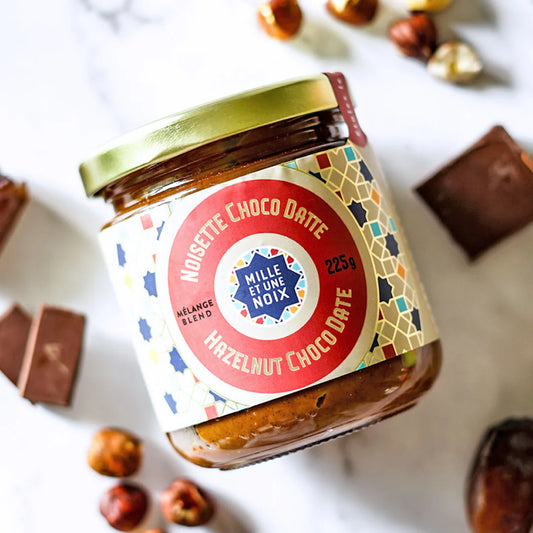 A jar of Mille et Une Noix hazelnut choco date butter, featuring a smooth, chocolatey spread made from hazelnuts and dates.