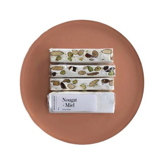 A package of Miels d’Anicet nougat with honey, featuring a soft, chewy confection with visible nuts in branded packaging.