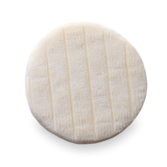 A round of Fromagerie La Suisse Normande Le Pizy cheese, featuring a soft, creamy interior with a delicate rind in
