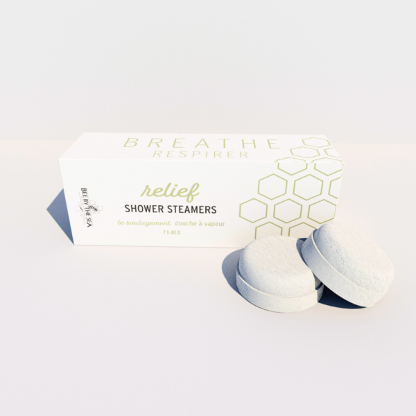 A box of "relief" shower steamers on a pale background, with two steamers sit in front of the box.