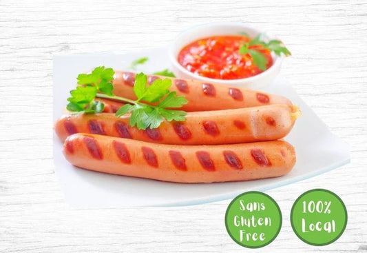 Les Fermes Valens wieners, featuring ready-to-cook sausages on a plate next to some sauce.