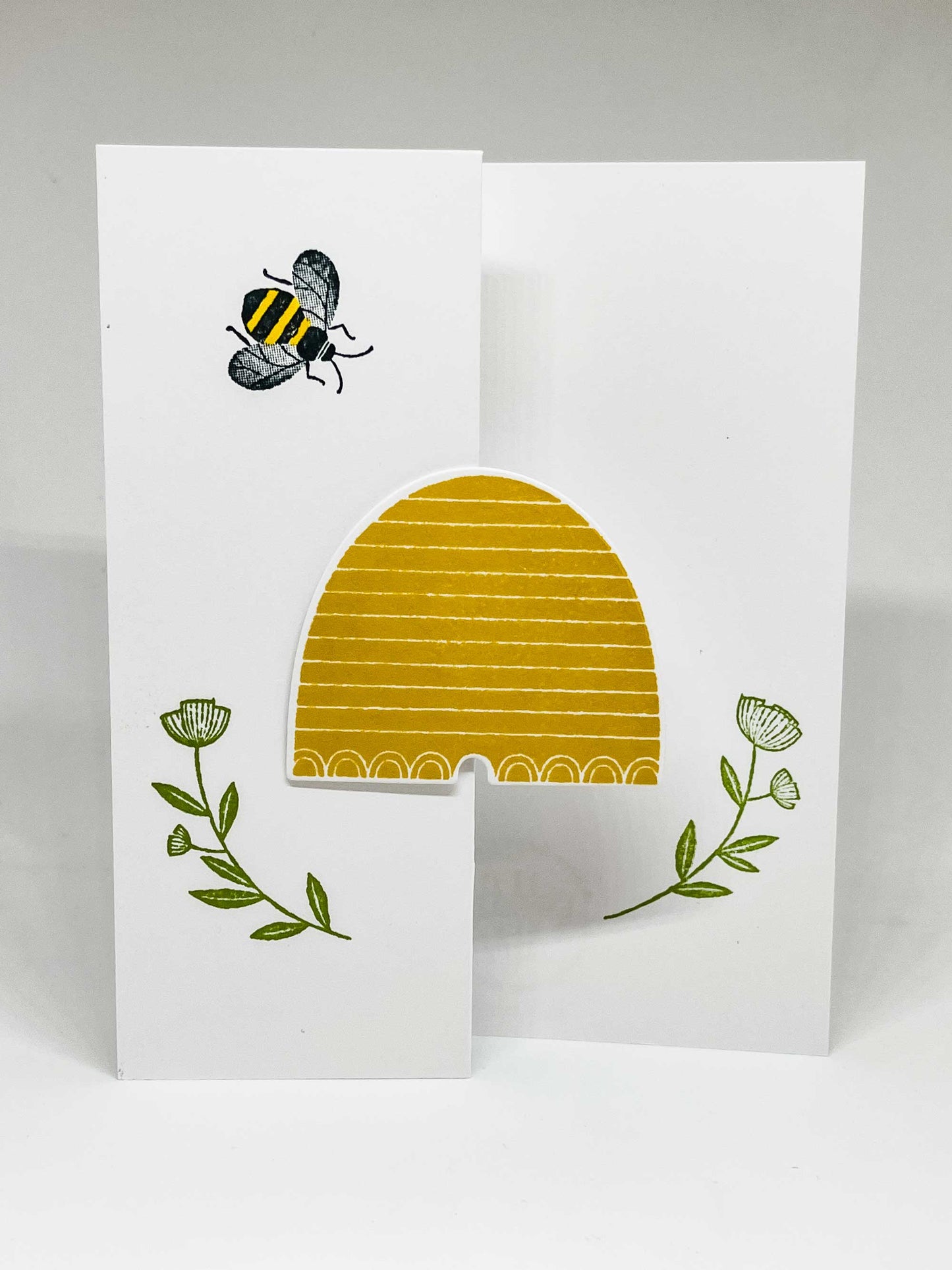 Tri-fold greeting card with hive, flowers and a honeybee