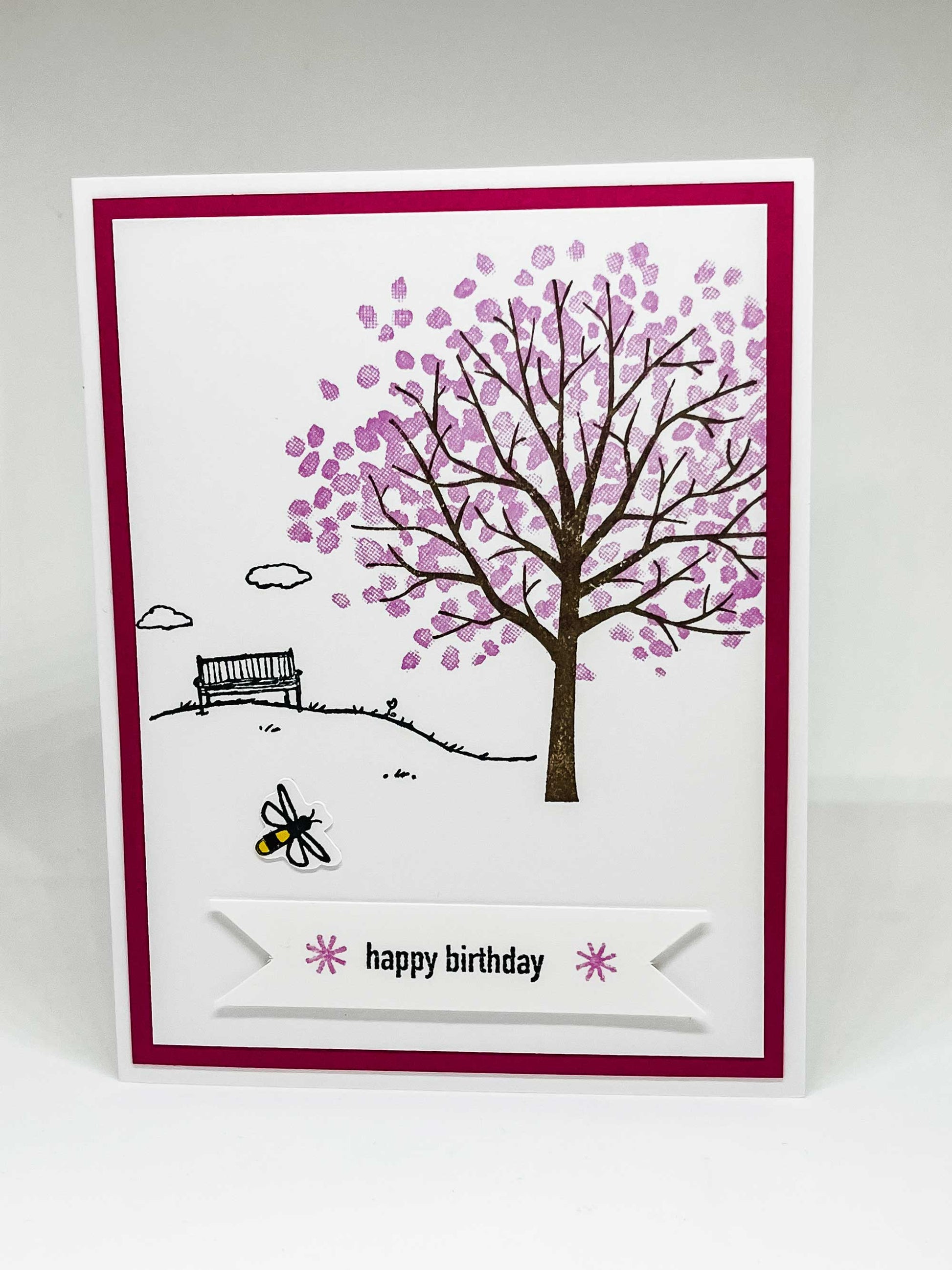 Pop-up greeting card with honeybee flying across a cherry blossom tree and text that says happy birthday