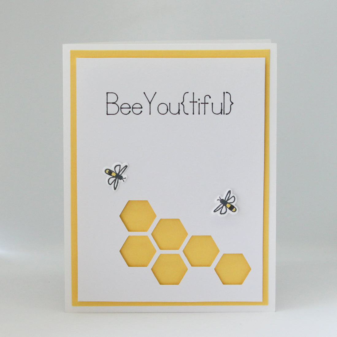 Bee and honeycomb birthday card that says bee-you-tiful