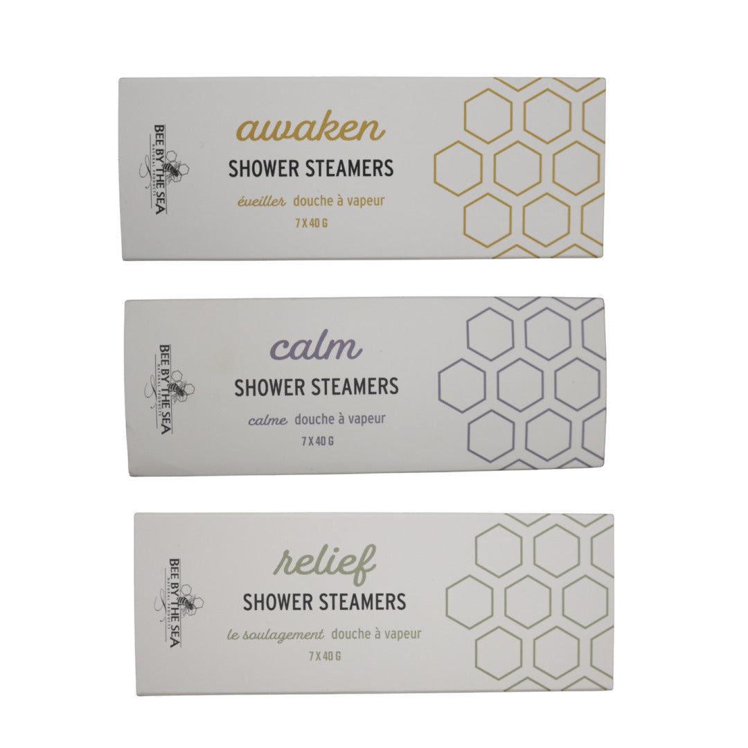 3 rectangular boxes of Shower Steamers, one above the other, sit on a white background