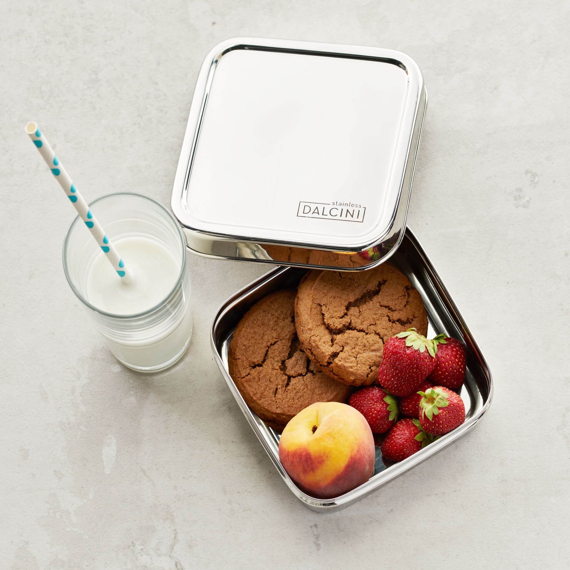 Cookies, strawberries, and peach in square stainless steel sandwich box with lid