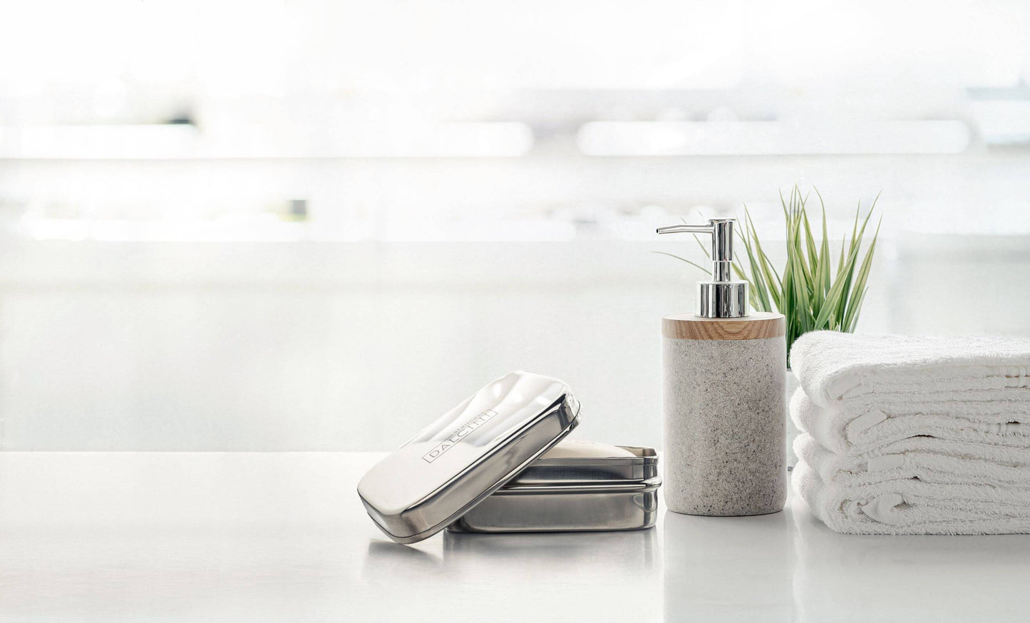 Food-grade stainless steel soap dish open on bathroom counter next to soap dispenser and folded white towels